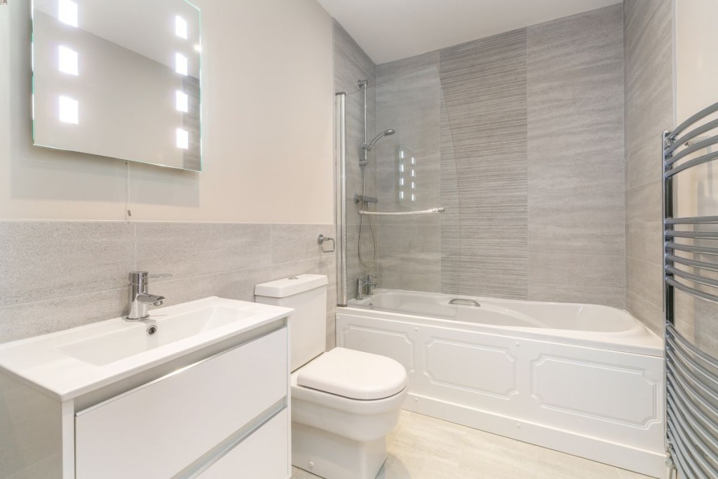 minimalist toilet and bathroom with white coloured accessories